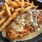 Chicken fillet in a spicy, creamy garlic-Parmesan sauce with French fries